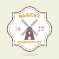Bakery badge or label in old or vintage style. Bakery and bread design elements with windmill symbol isolated on white background. Royalty Free Stock Photo